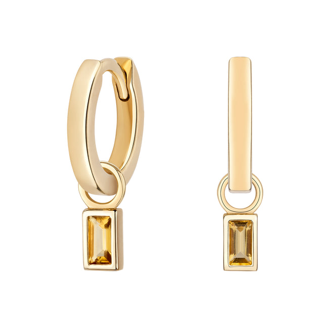 Gold hoop earrings with rectangular gemstones on a white background