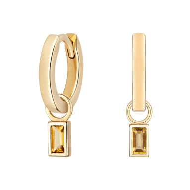 Gold hoop earrings with rectangular gemstones on a white background